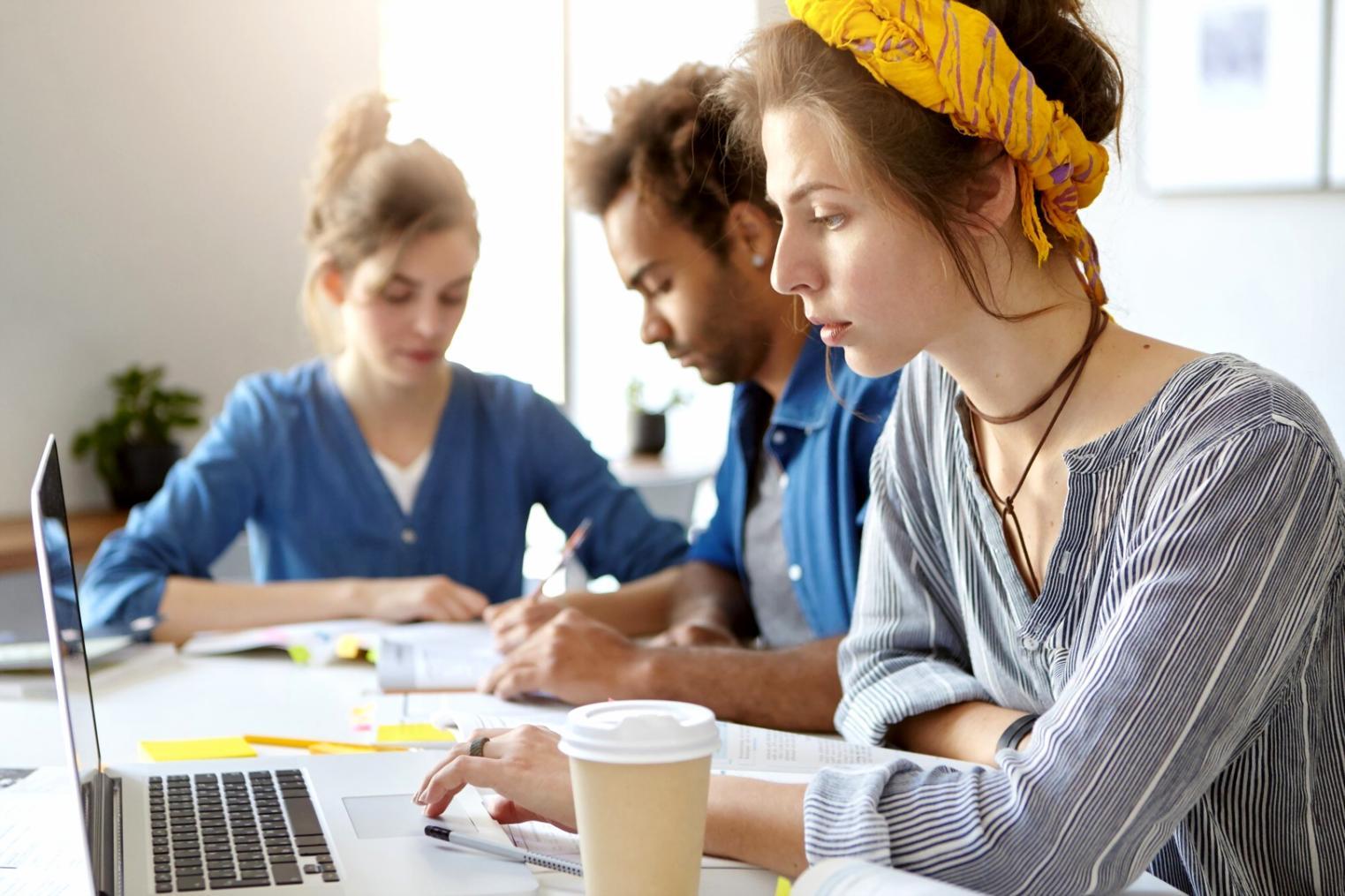Student reviewing personalised financial learning materials on tablet with multiple study formats visible